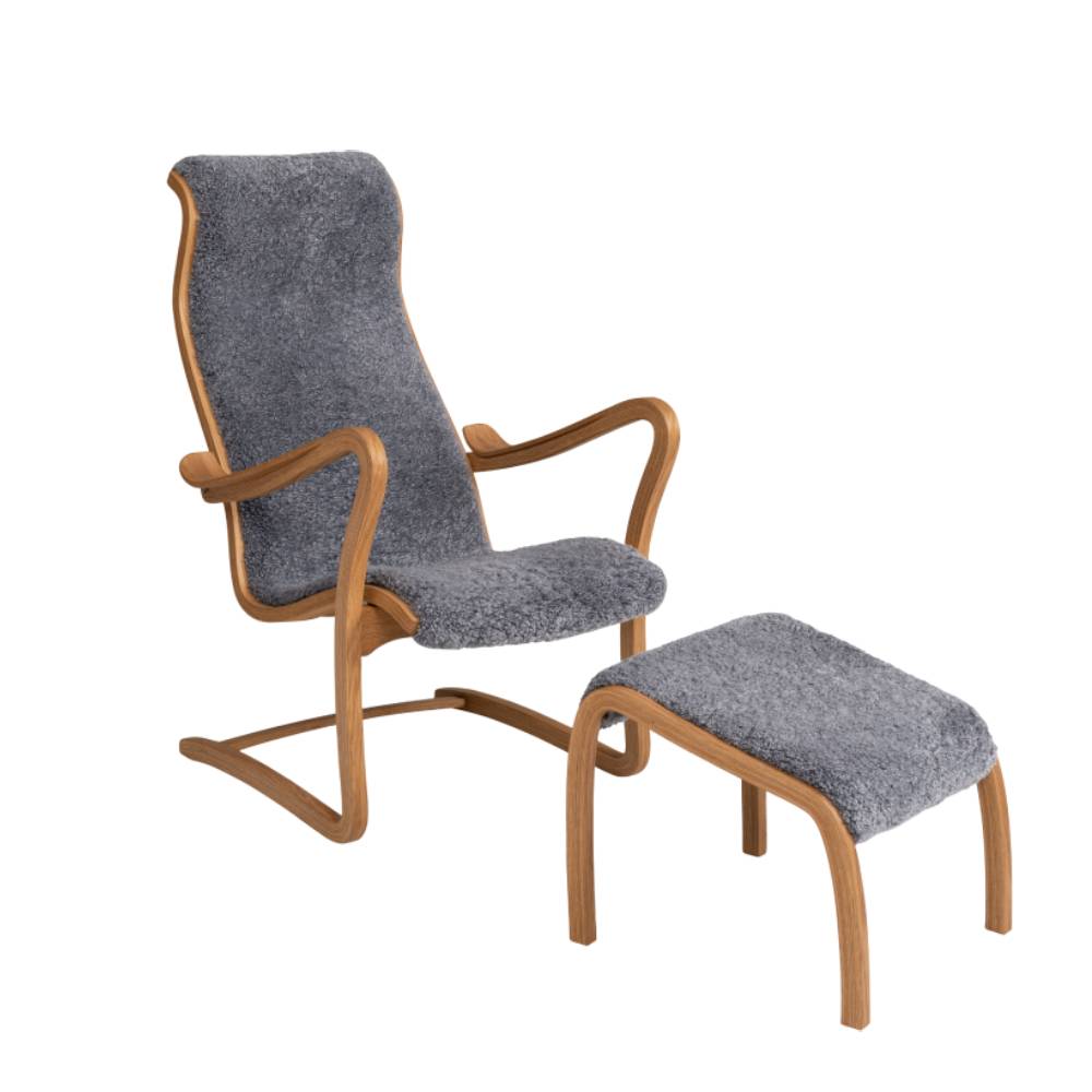 Patronen fåtölj med svikt och tillhörande fotpall, fårskinn Scandinavian Grey och stomme i ek, från Bröderna Anderssons.